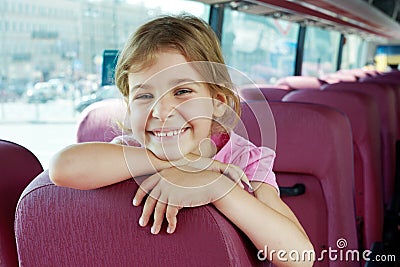 Portrait of smiling girl on bus seat