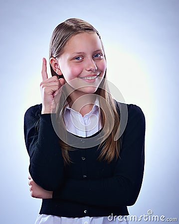 Portrait of a smiling teen girl with finger up