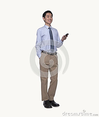 Portrait of smiling young businessman using his phone, full length, studio shot