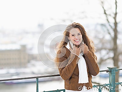 Portrait of smiling young woman in winter jacket outdoors