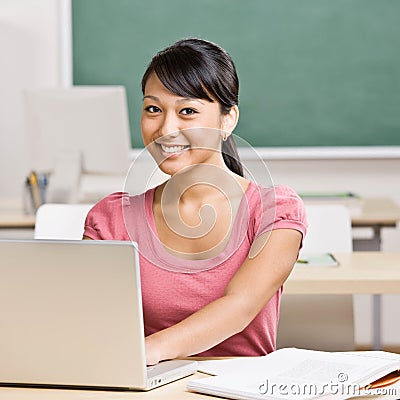 Portrait of student sitting at desk in classroom