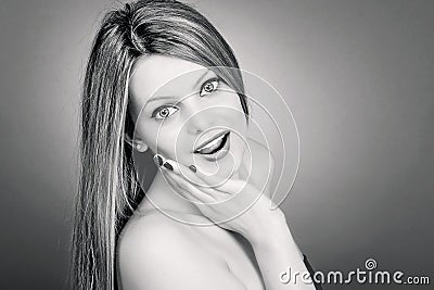 Portrait of surprised beautiful girl holding hand on her face in