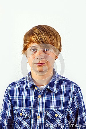Portrait of a teen boy with blonde hair wearing a checked shirt