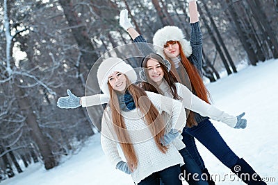 Portrait of three beautiful girls in winter park