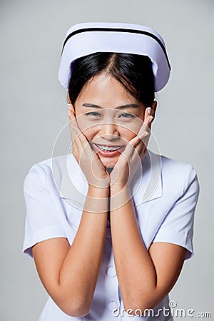 Portrait of very happy young Asian nurse