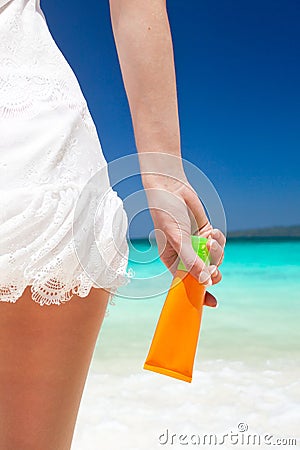 Portrait of woman holding sunscreen cream