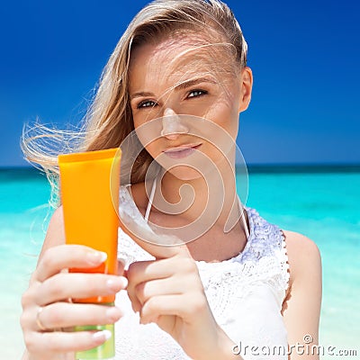 Portrait of woman holding sunscreen cream