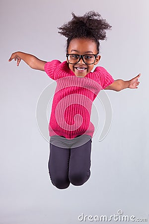 Portrait of Young African American girl jumping
