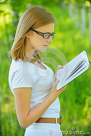 Portrait of young beautiful woman holding book