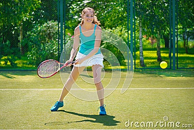 Portrait of young beautiful woman playing tennis