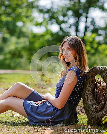 Portrait of young beautiful woman relaxing in summer forest