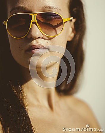 Portrait of a young beautiful woman with sun glasses