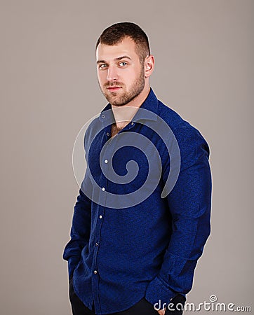 Portrait of a young business man in the blue shirt