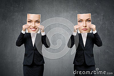Portrait of young business woman hiding her mood under masks