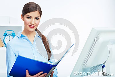 Portrait of young business woman working with paper at computer