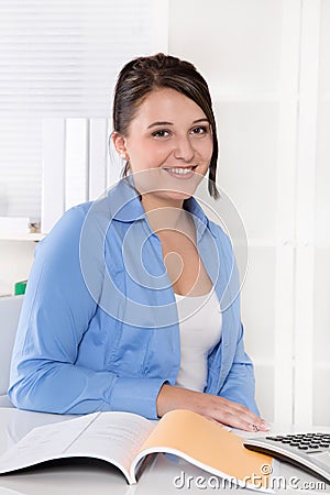 Portrait of a young businesswoman in blue blouse.