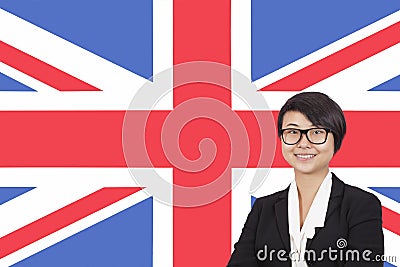 Portrait of young businesswoman smiling over British flag