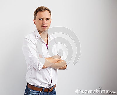 Portrait of young creative man standing with arms crossed