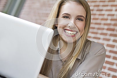 Portrait of young female student using a laptop