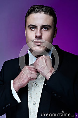 Portrait of young handsome groom in suit