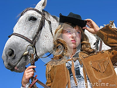Portrait of young unhappy cowgirl with horse