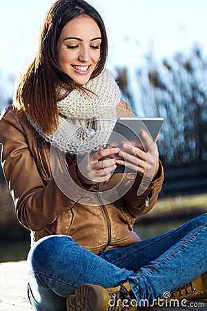 Portrait of young woman with digital tablet