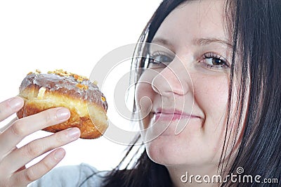 Portrait of a young woman eating a donut