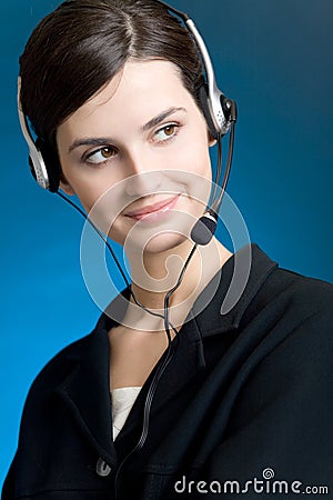Portrait of young woman with headset, on blue background, smiling