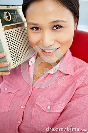 Portrait of young woman listening to radio