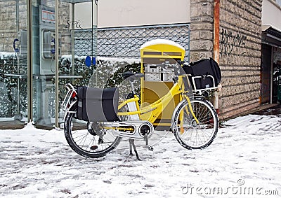 Postal delivery in bike in winter