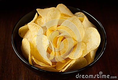 Potato chips on dark background - snack bar menu