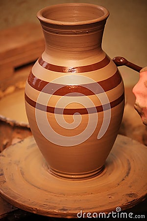 Potter painting a water jug