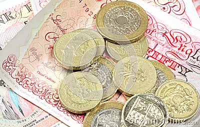 Pound coins on money background