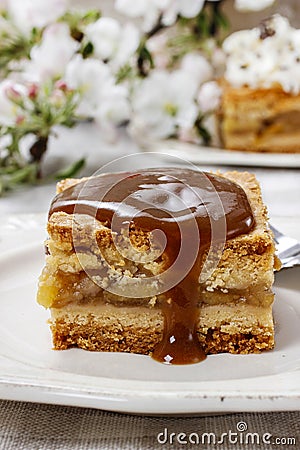 Pouring caramel sauce on piece of apple pie