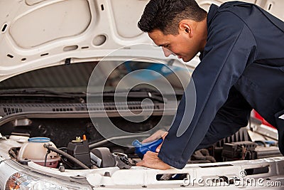 Pouring new oil into a car