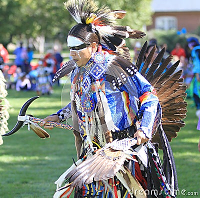 Pow wow man dancer face paint and feathers