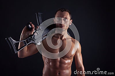 Powerful young man with rifle