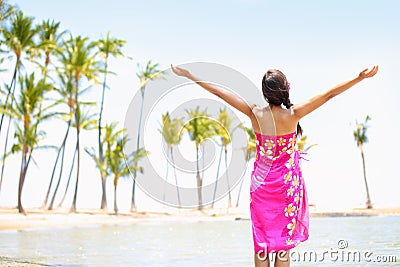 Praising happy freedom woman on beach in sarong