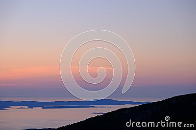 Pre-dawn golden glow from the top of Cadillac Mountain with the