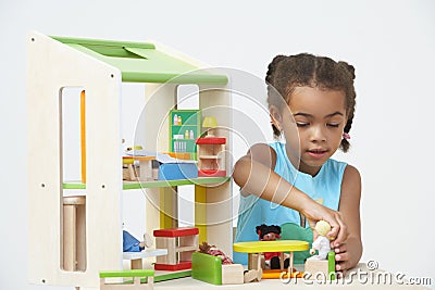 Pre-School Pupil Playing With Wooden House