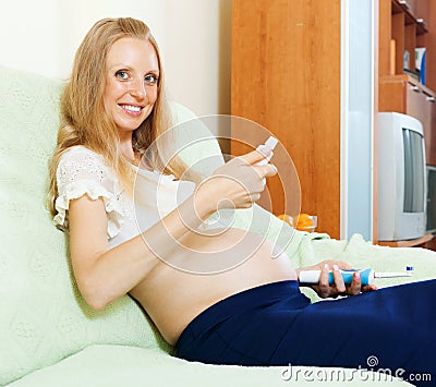 Pregnancy woman looking dental cream