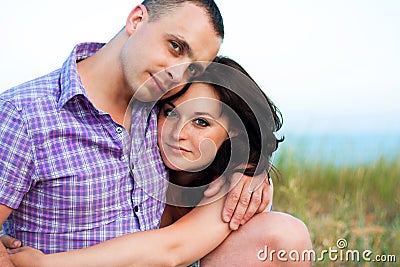 Pregnancy. Young loving couple on the beach.