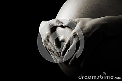 PREGNANT BELLY WITH HEART SHAPE HANDS