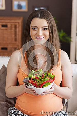 Pregnant woman with fresh veggies