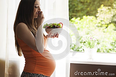 Pregnant woman with fresh veggies