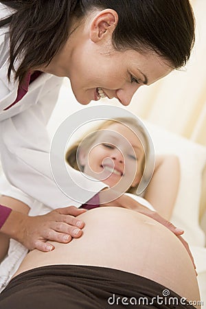 Pregnant woman getting check up from doctor