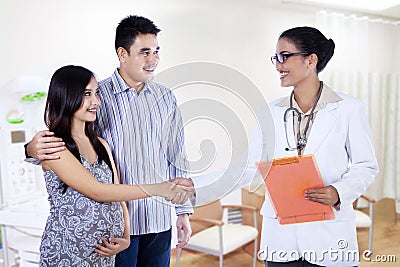 Pregnant woman hand shake with a doctor