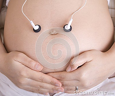 Pregnant woman listens to music