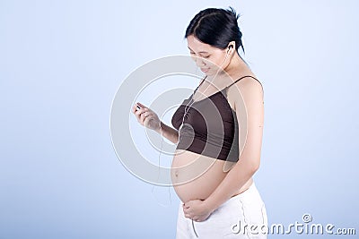 Pregnant woman listens to music