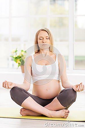 Pregnant woman meditating.